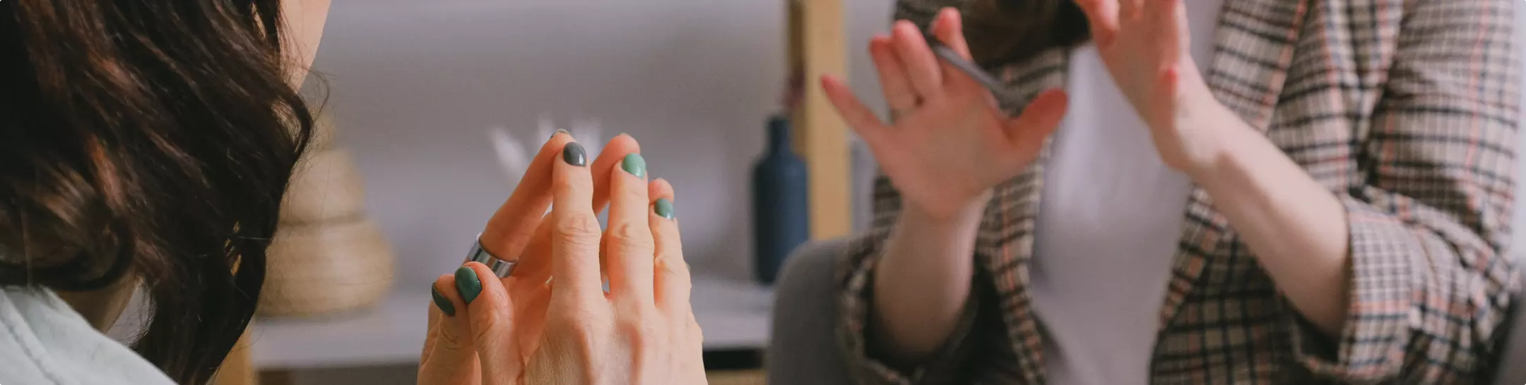 Close up two women talking to each other at the office